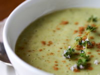 bowl of pale green garlic soup in closeup