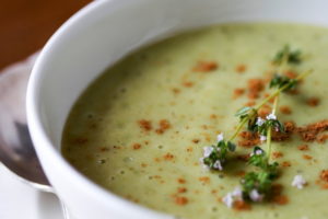 bowl of pale green garlic soup in closeup